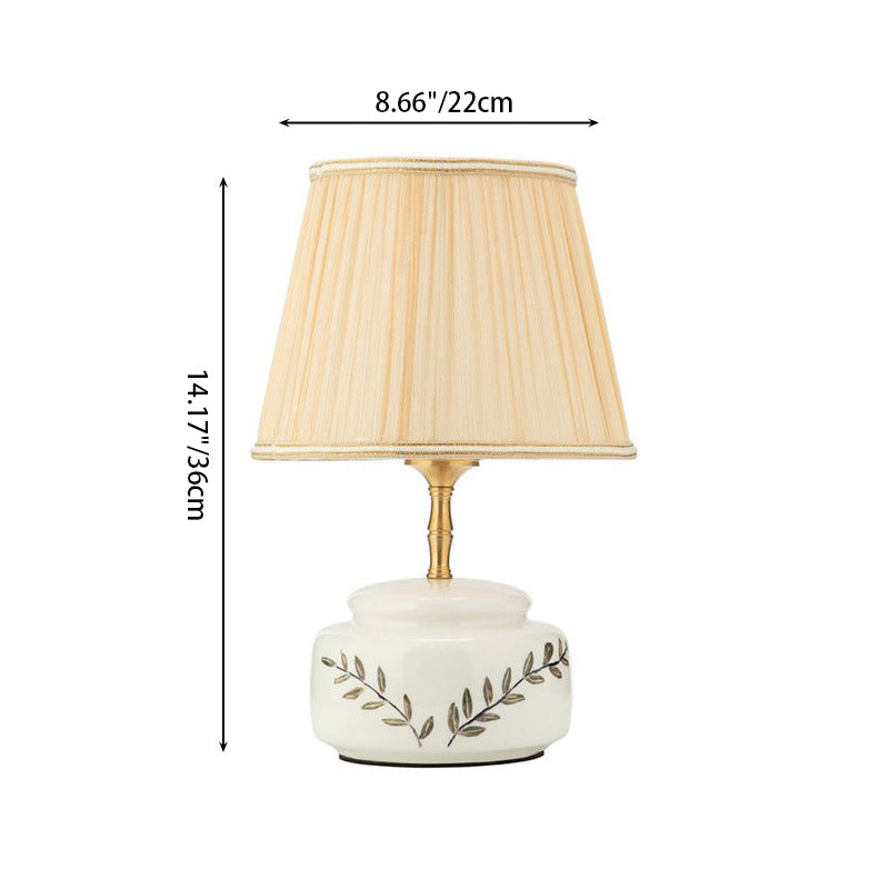 Lampe de table à 1 lumière avec abat-jour en tissu plissé trapézoïdal contemporain et base en céramique ronde pour chambre 