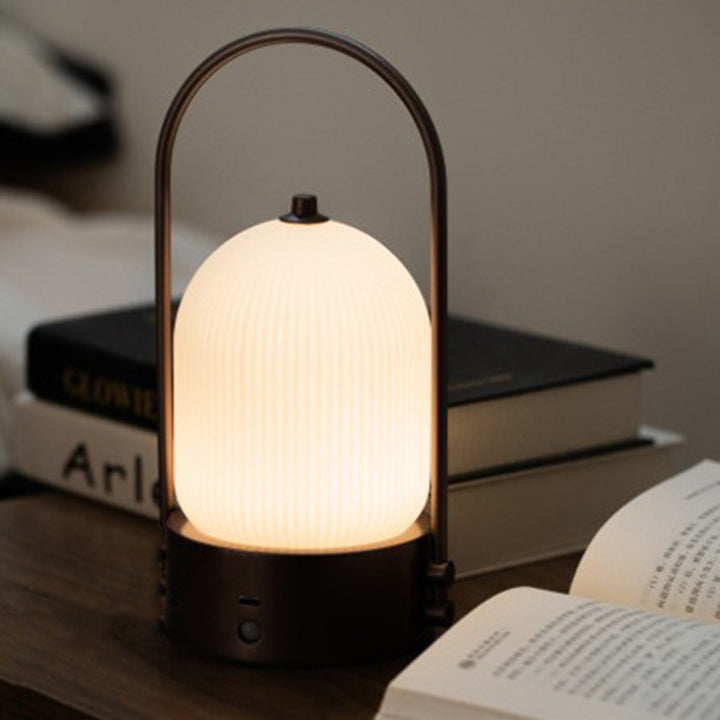 Lámpara de mesa LED USB portátil inductiva de vidrio y hierro metálico ovalado minimalista moderno para dormitorio 