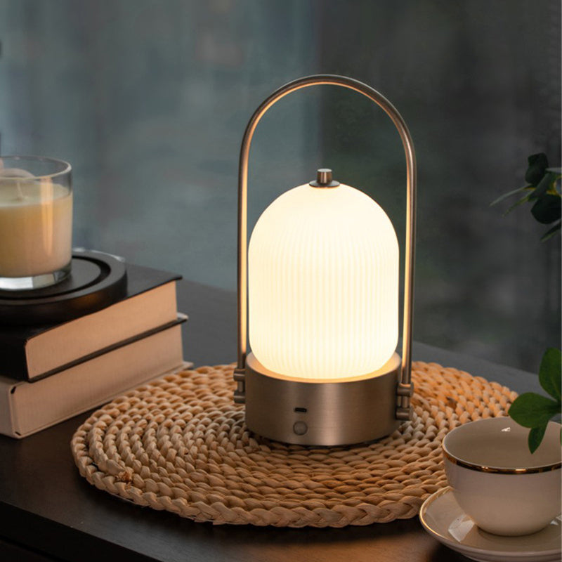 Lámpara de mesa LED USB portátil inductiva de vidrio y hierro metálico ovalado minimalista moderno para dormitorio 