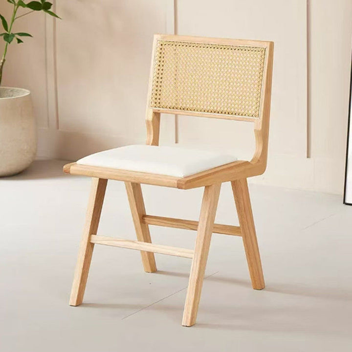 Moderna silla de comedor sin brazos de goma en forma de H nórdica contemporánea con respaldo de ratán tejido y esponja de cuero PU para el comedor 