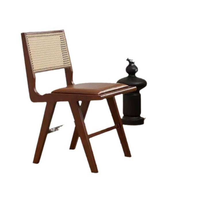 Moderna silla de comedor sin brazos de goma en forma de H nórdica contemporánea con respaldo de ratán tejido y esponja de cuero PU para el comedor 