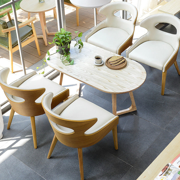 Zeitgenössischer skandinavischer hohler gebogener ovaler PU-Leder Massivholz Esszimmerstuhl Rückenlehne für Esszimmer 
