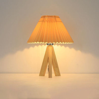 Lámpara de mesa de 1 luz con pantalla de tela plisada trapezoidal minimalista moderna y trípode de madera para dormitorio 