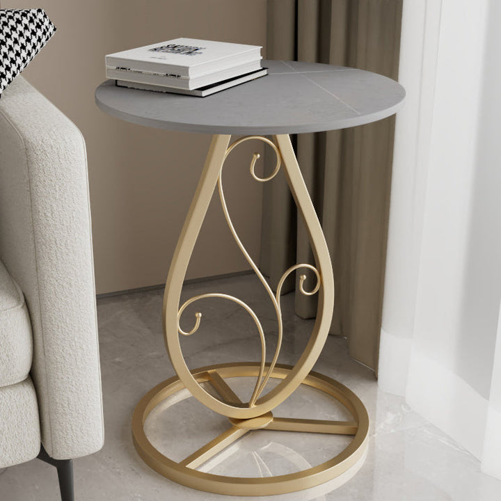 Table basse moderne de luxe ronde avec plateau en pierre frittée et base en métal pour salon 