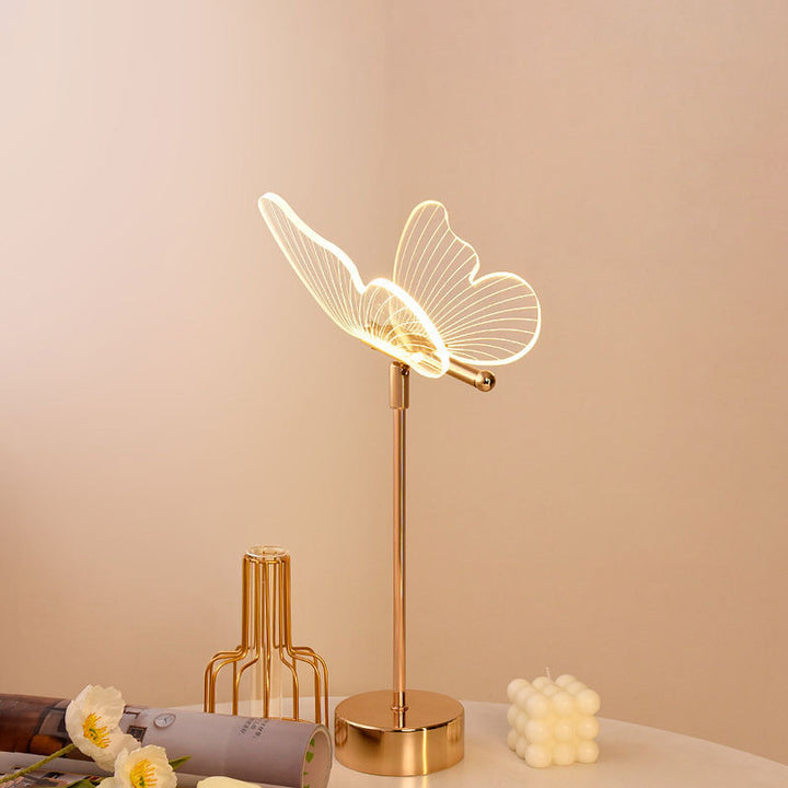 Moderne minimalistische LED-Tischlampe aus Acryl mit Blumen- und Schmetterlingsmotiv in Gold für das Schlafzimmer 