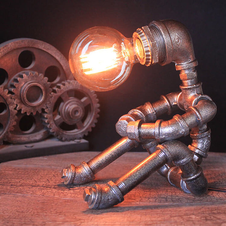 Lampe de table robot assis en fer industriel créatif 